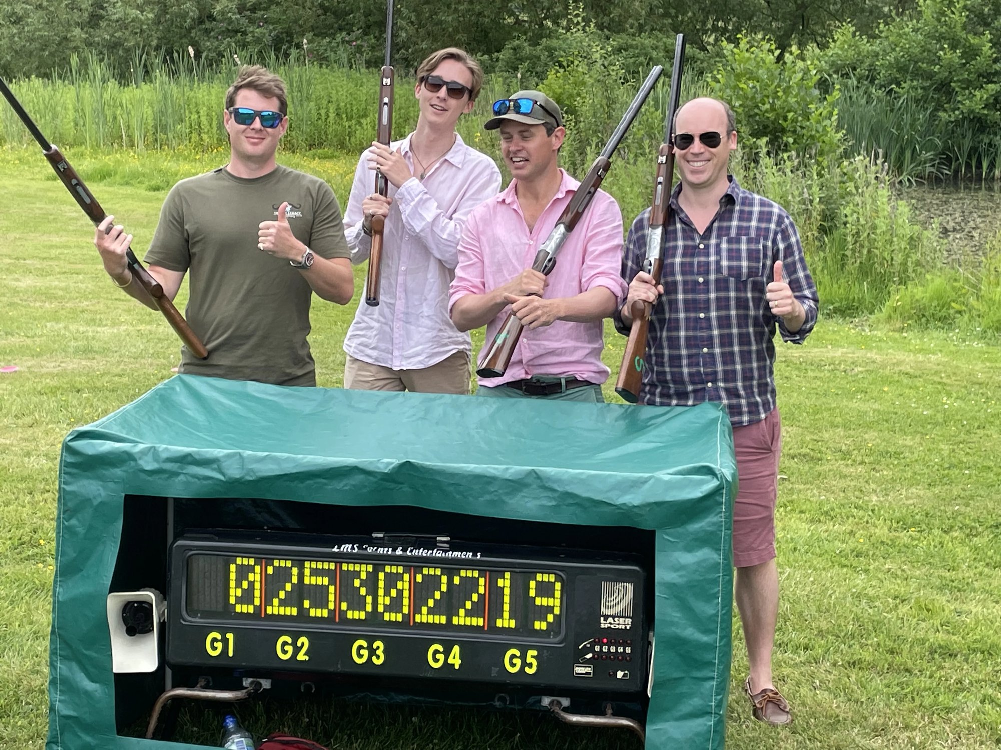 Winning team celebrating at the laser clay scoreboard