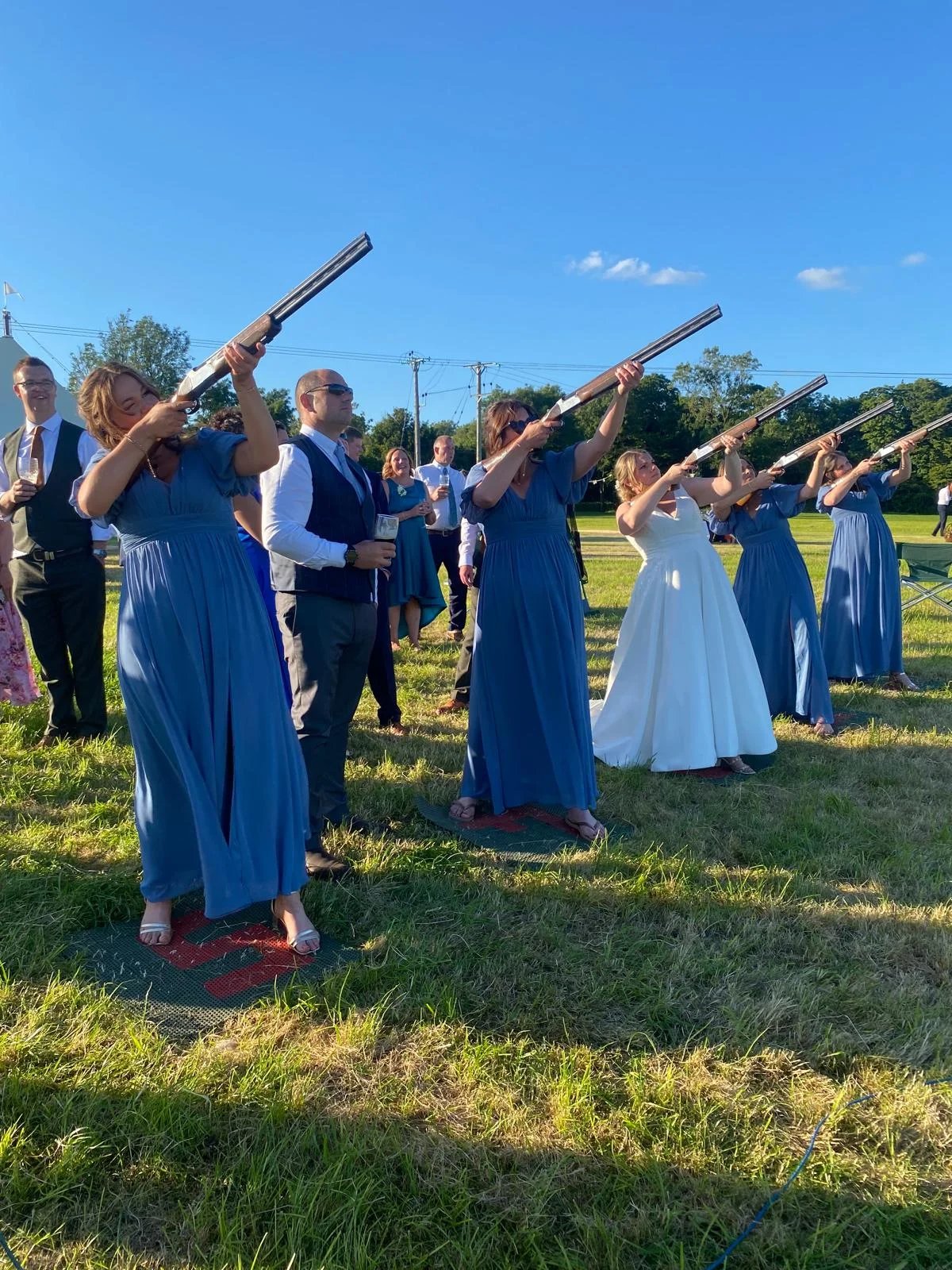 Wedding guests shooting together on a summer afternoon